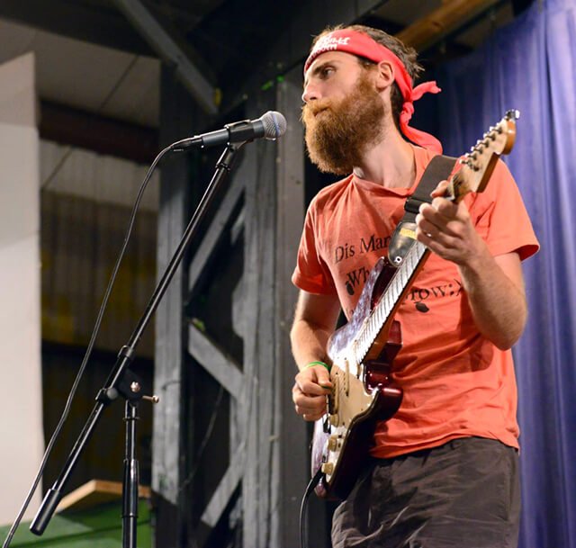 Ronnie Smith plays guitar on stage