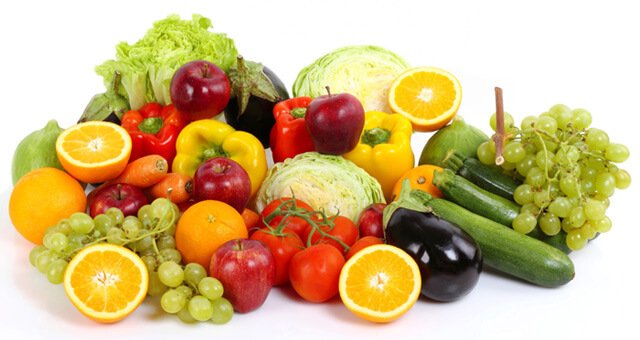 A spread of fruits and vegetables on a white background