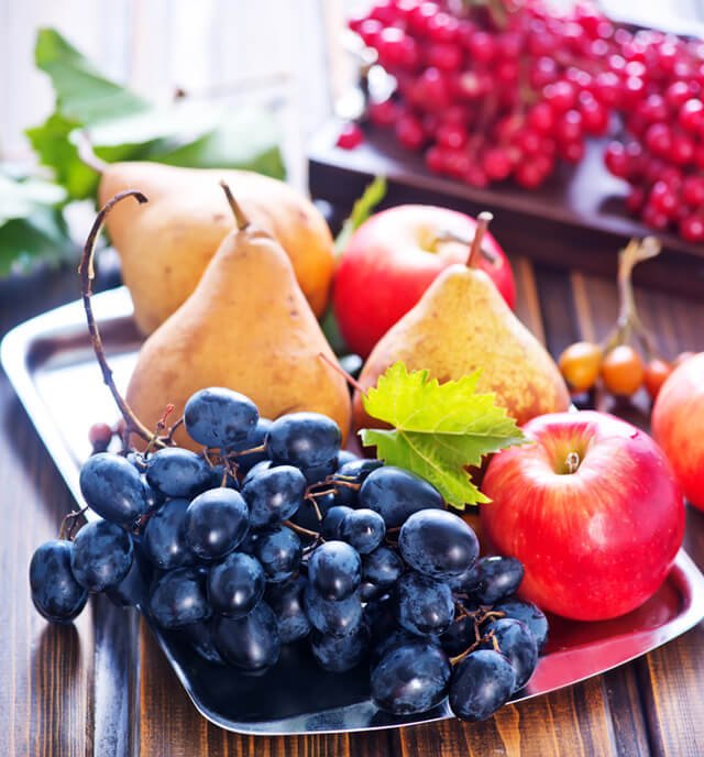 Blueberries, apples and peaches on a table