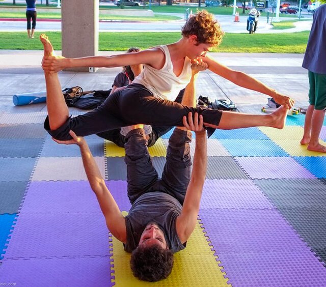 Katy Craine practices acro on mats outside