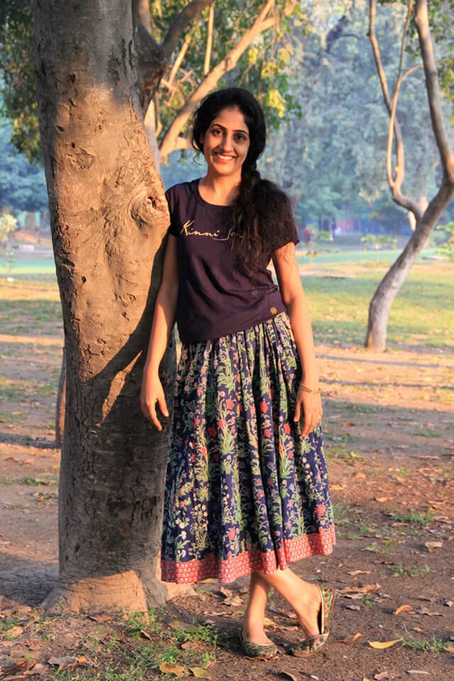 Rupinder Kaur leans against a tree