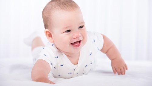 A baby looks into a camera