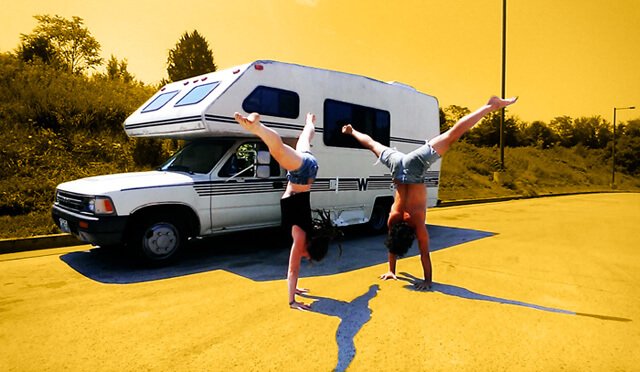 Brittany Taylor and Conor McMillen practice handstands outside a motorhome