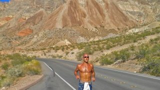 Jeff Sekerak runs along a road by Lake Mead