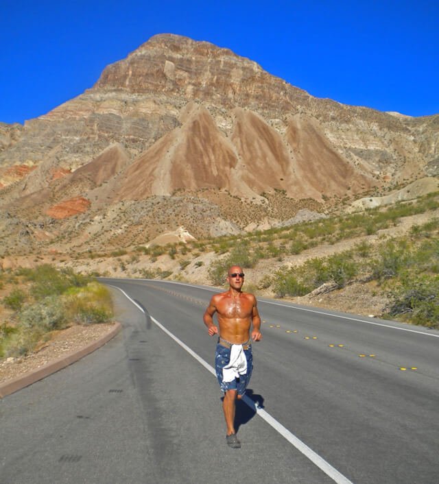 Jeff Sekerak runs along a road by Lake Mead