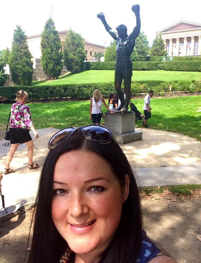 Marta Csuka poses at the Rocky statue
