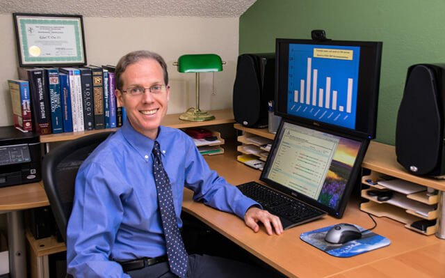 Rick Dina at his desk in 2015