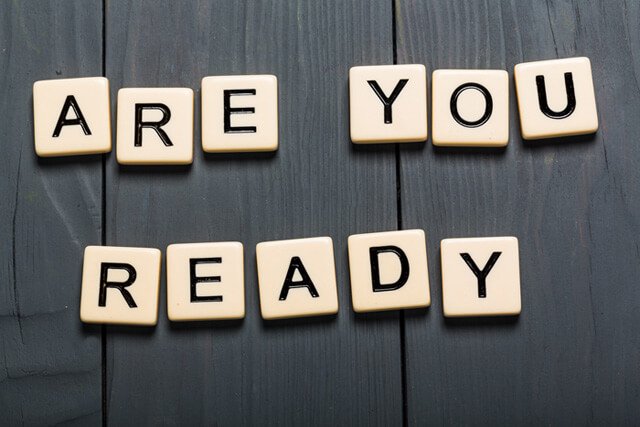 Block letters spell out "Are you ready" on a table