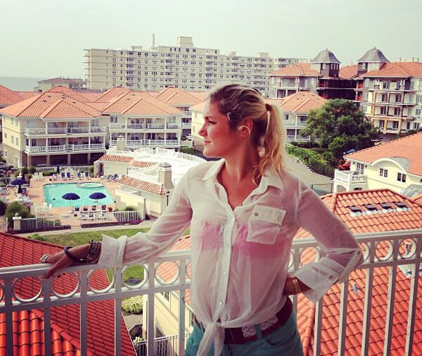 Anastasia Voss looks out across a city from a balcony