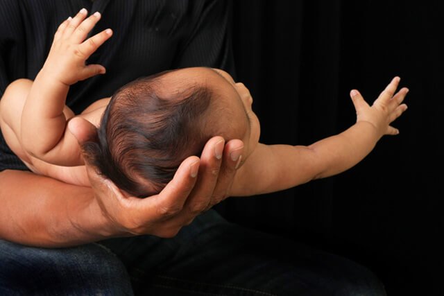 A father cradles his baby