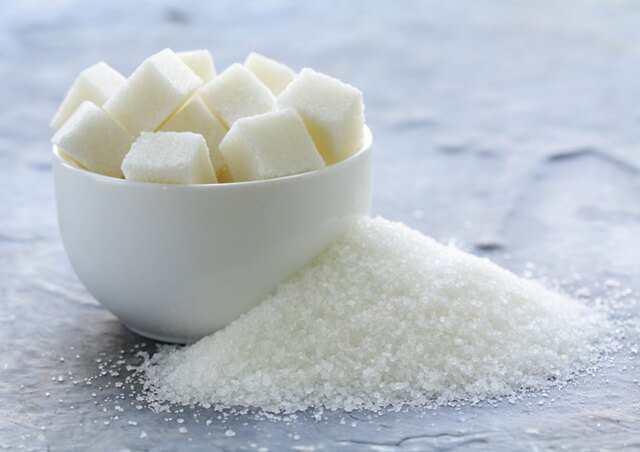 Granulated and refined sugar on a table