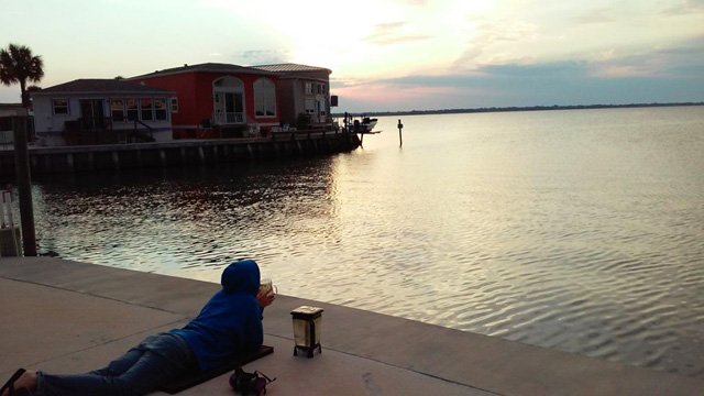 Tasha Lee enjoys a smoothie while overlooking a waterfront