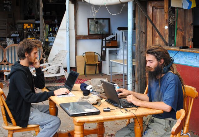 Mads and Mikkel Gisle Johnsen work on laptops in La Palma