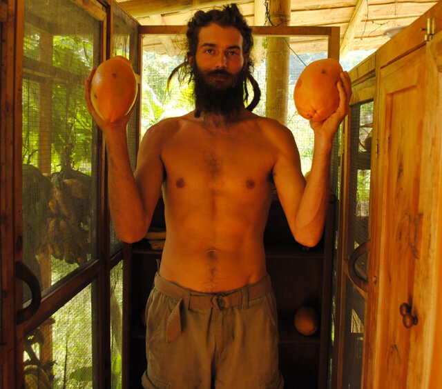 Mikkel Gisle Johnsen holds fruits up high