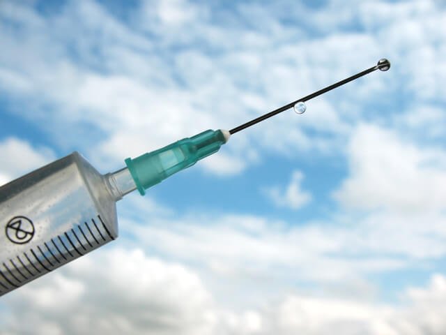 Vaccine shot on a background of the sky