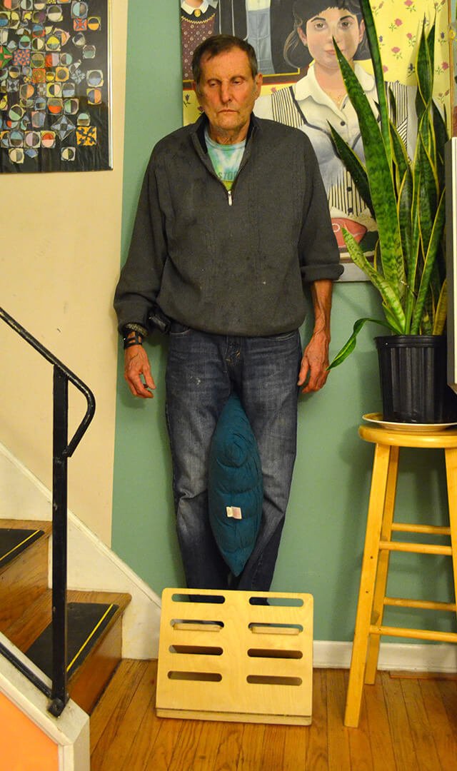 Arnold Kauffman practices Wall Drop, an Egoscue Method exercise