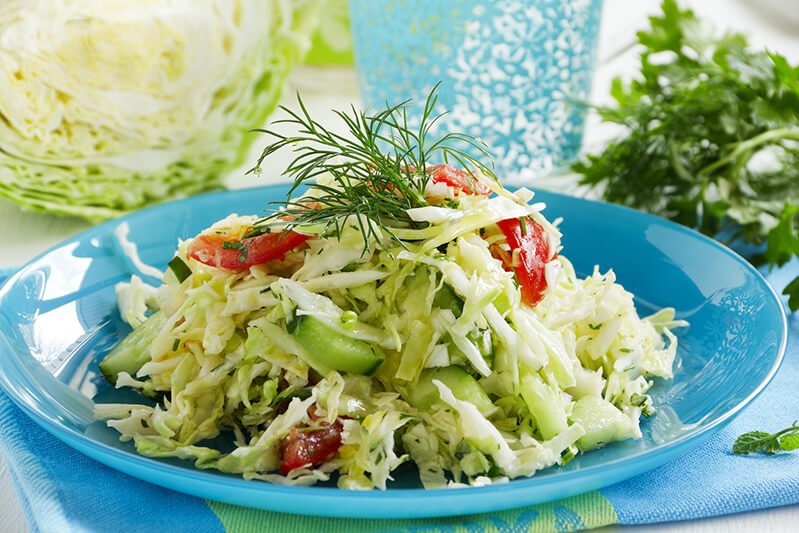 A salad with lettuce, tomato and cucumber