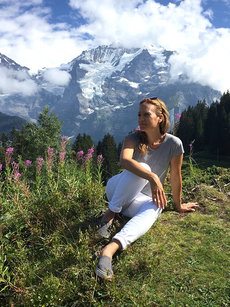 Amy Yuter sits on a scenic hillside