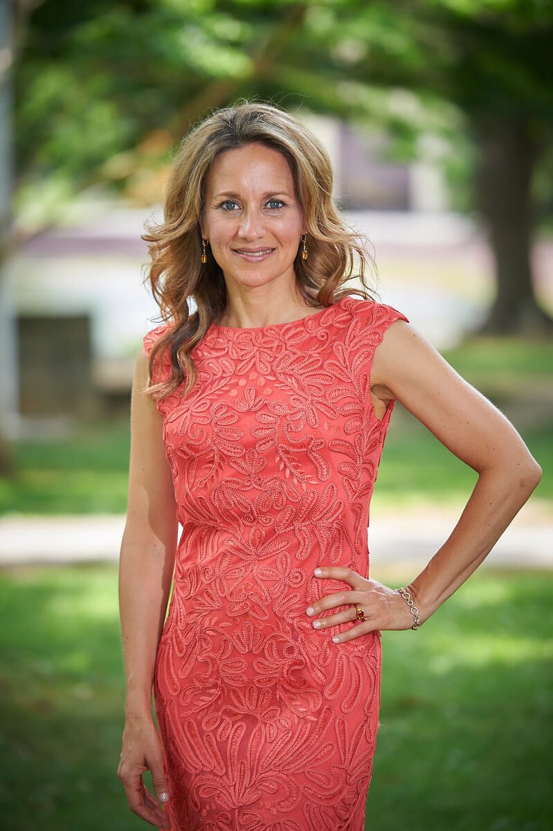 Amy Yuter poses outside with a hand on her waist