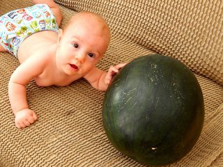 The Cech baby beside a watermelon