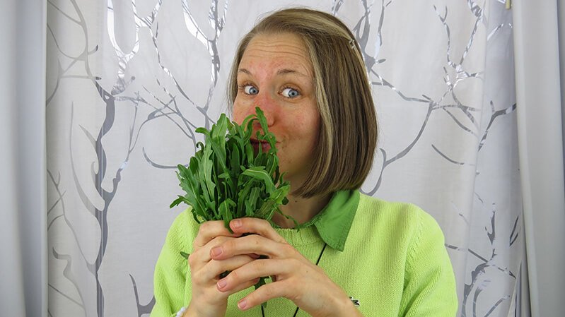 Eva Straub holds dandelion in front of her face