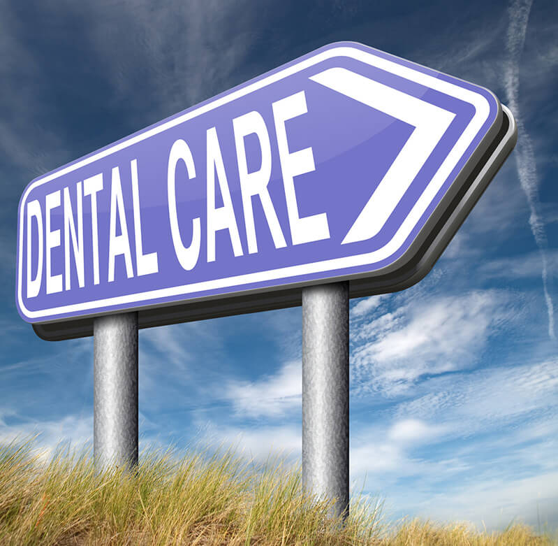 A road sign says "Dental Care"