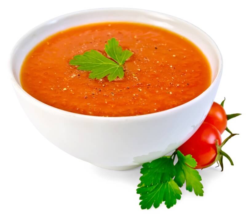 Essential oils of basil added to a bowl of tomato soup 
