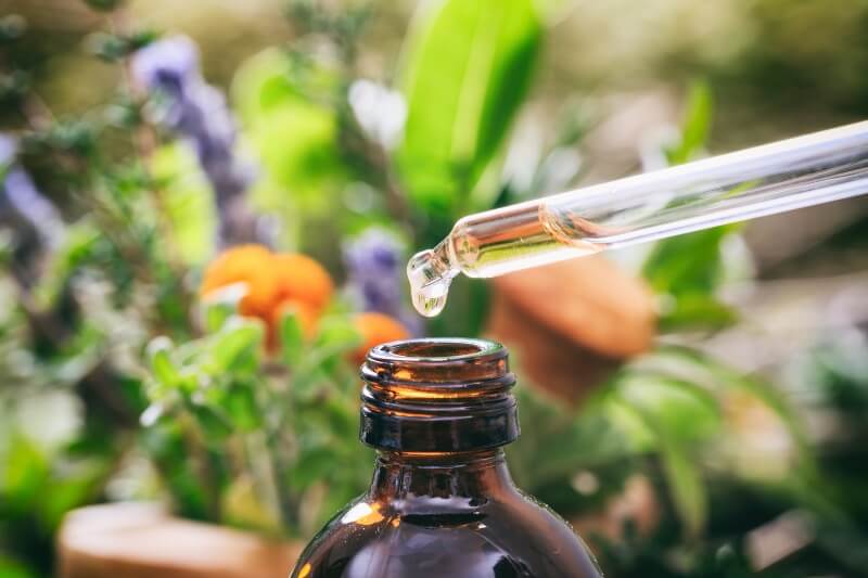 Essential oils are pulled from an amber bottle
