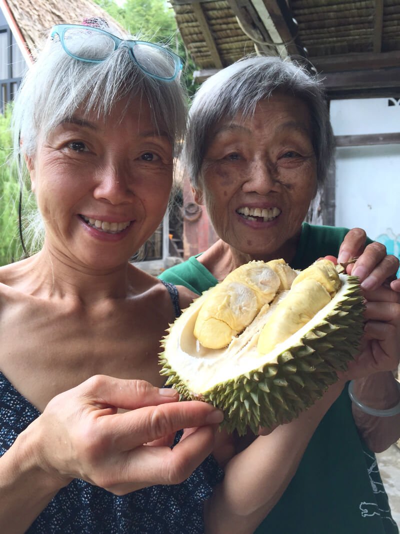 Ping Chan holds durian with her mother