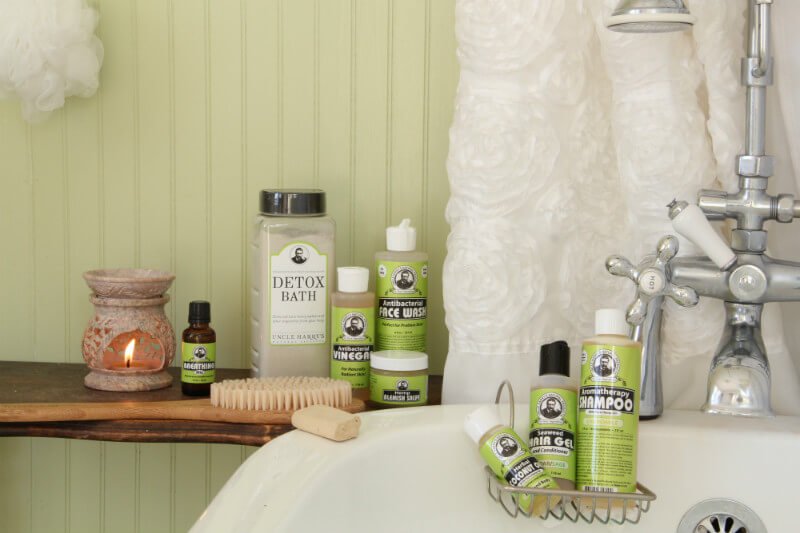Uncle Harry's Natural Products for bathing and detoxification photographed beside a bathtub and shower