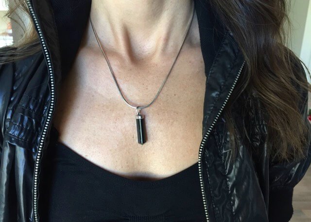 Alicia Grant wears an obsidian gemstone pendant