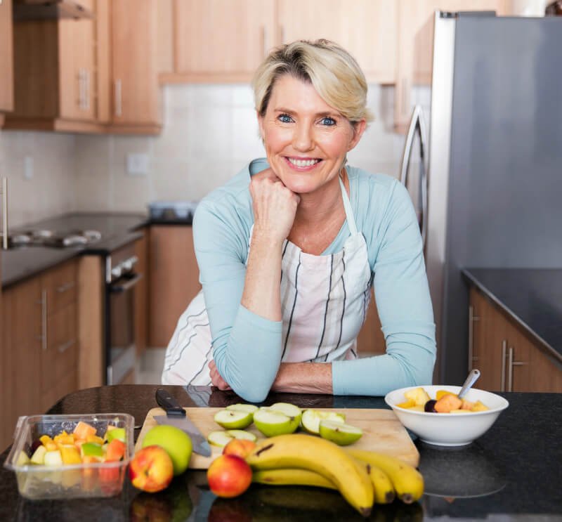 Middle-age woman prepares fruit recipes