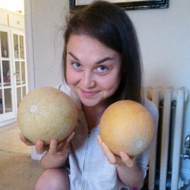 Aliyah Washington holds cantaloupes - Tips for Transitioning to a Raw Food Diet Intelligently