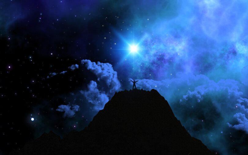 Dark night of the soul - emotional release - man summiting mountain at night under stars - Fruit-Powered