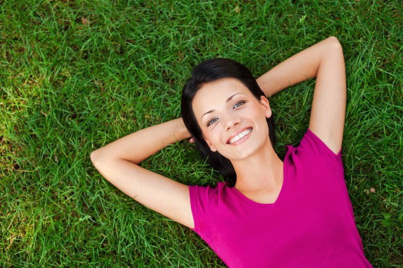 Neuro Emotional Technique - NET - woman relaxing on grass - Fruit-Powered