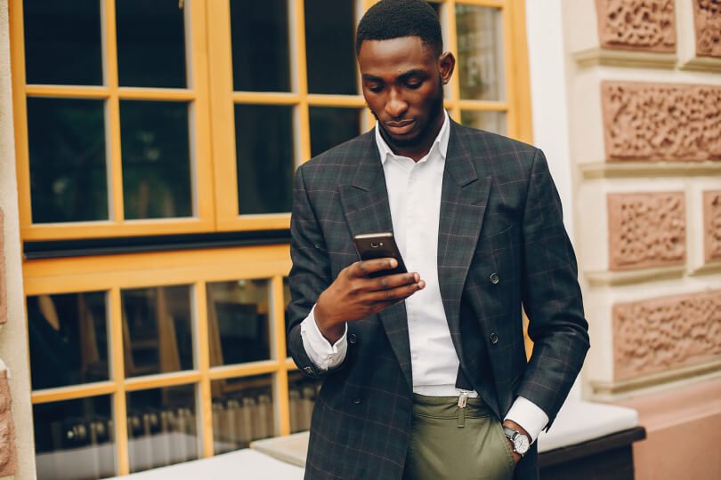 Proper standing posture - man hunched over cell phone - Posture Exercises Method - Fruit-Powered