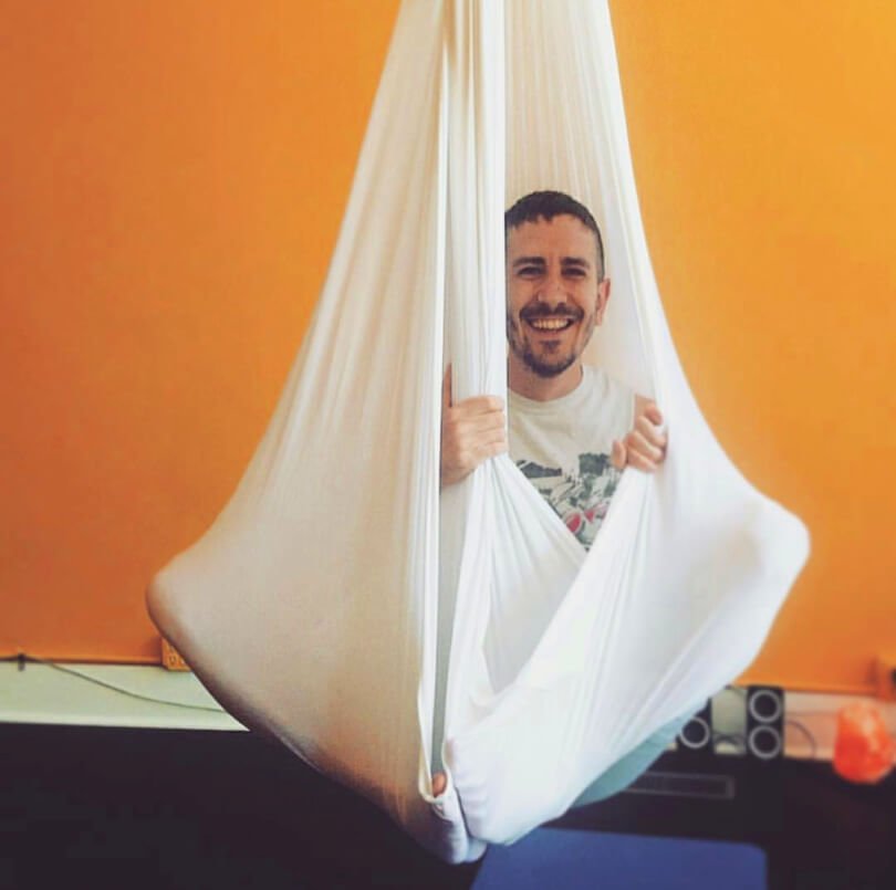 TJ Long playing in a yoga swing - Raw Vegan Transformations - Fruit-Powered