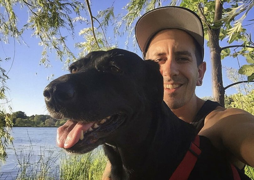 TJ Long posing with dog Brooks - Raw Vegan Transformations - Fruit-Powered