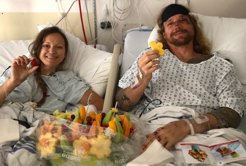Chris Kendall and Kamilla Jonvik holding fruit in a hospital - Fruit-Powered